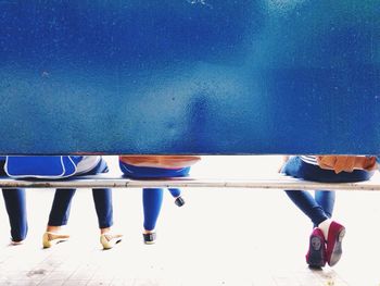 Low section of women sitting on bench