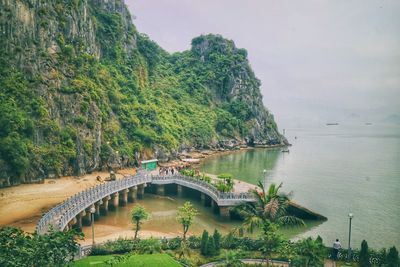 Arch bridge over sea against sky