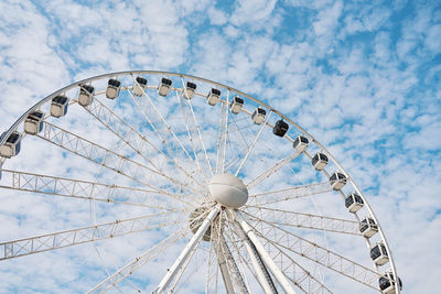 Low angle view of ferris wheel against sky