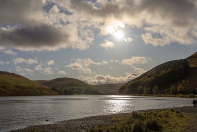 Scenic view of lake and mountains against sky