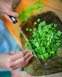 Cropped hands cutting vegetables