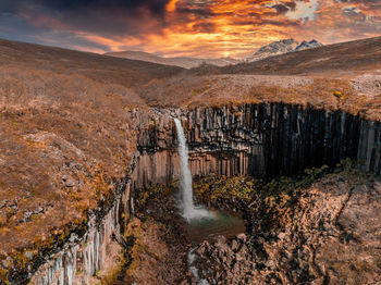 Aerial view of the svartifoss waterfall surrounded by basalt columns