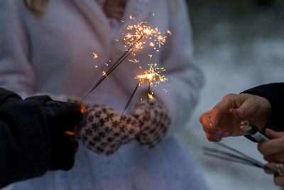 People igniting sparklers