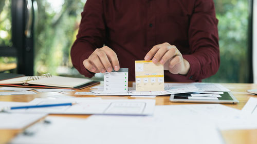 Midsection of business colleagues working on table