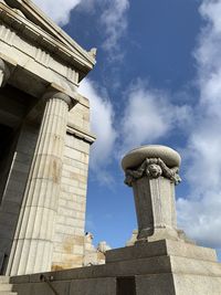 Low angle view of cross against cloudy sky