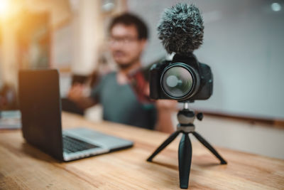 Man photographing with smart phone on table