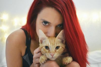 Portrait of beautiful young woman with cat