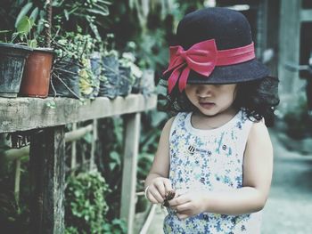 Cute girl looking up while standing outdoors