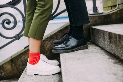 Low section of woman and man on steps