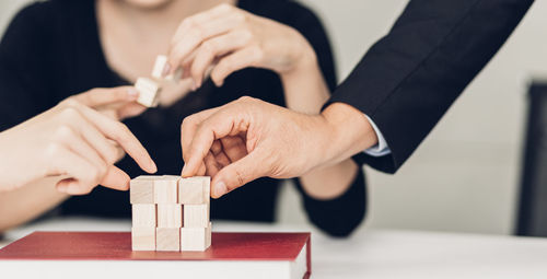 Close-up of hand holding hands on table