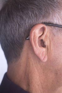 Close-up of man with hearing aid