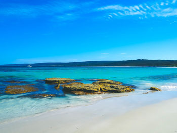 Scenic view of sea against blue sky