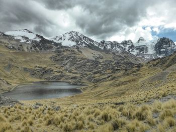 Scenic view of mountains against cloudy sky