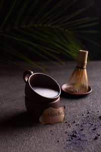 Cups of blue matcha tea with milk and powdered tea on the table