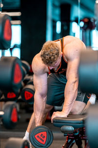 Side view of man exercising in gym