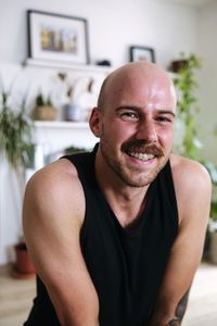 Smiling man wearing tank top at home