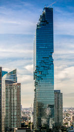 Modern buildings in city against sky