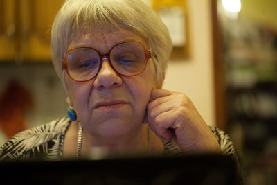 Senior woman using laptop at home