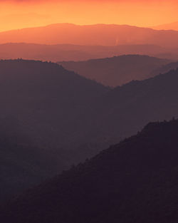 Scenic view of silhouette mountains against sky during sunset