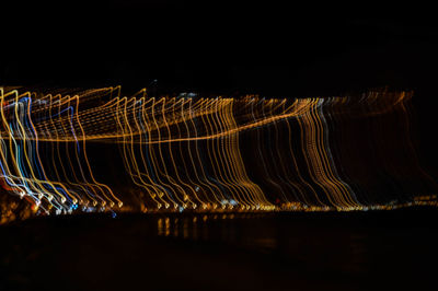 Light trails against sky at night