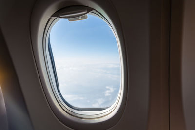 Cloudy sky seen through airplane window