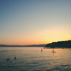 Scenic view of lake against clear sky during sunset