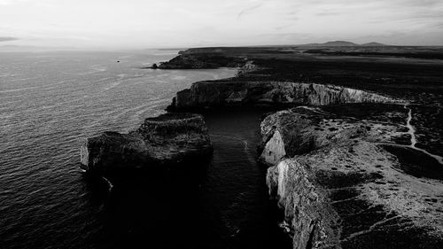 High angle view of rocks on beach against sky