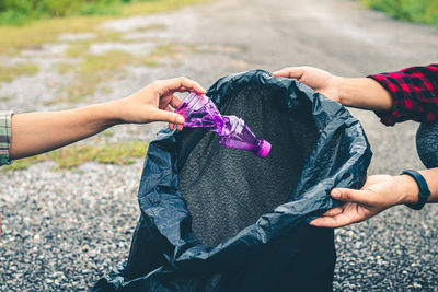 Midsection of woman holding purple outdoors