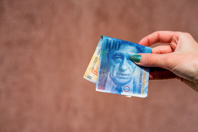 Cropped hand holding paper currency