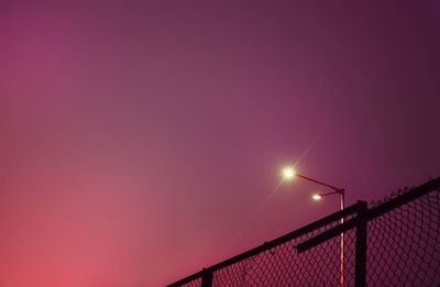 Low angle view of illuminated street light against sky during sunset