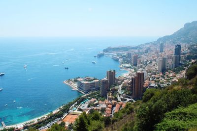 High angle view of buildings by sea in city