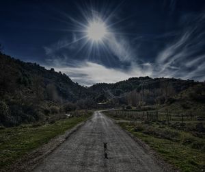 Road amidst mountains against sky