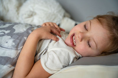 Close-up of baby sleeping on bed at home