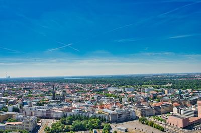 High angle view of buildings against blue sky