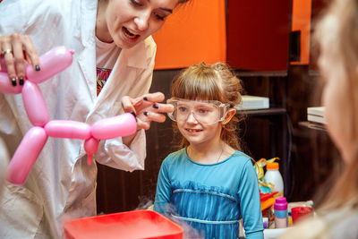 Portrait of siblings playing with toys at home