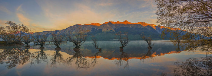 Scenic view of lake against sky during sunset