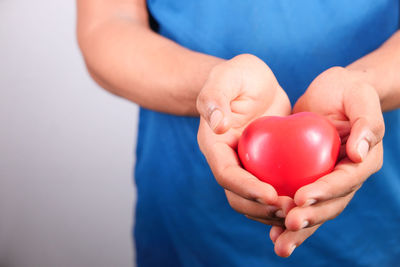 Close-up of woman holding red hand