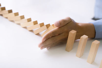 Close-up of hand over white background