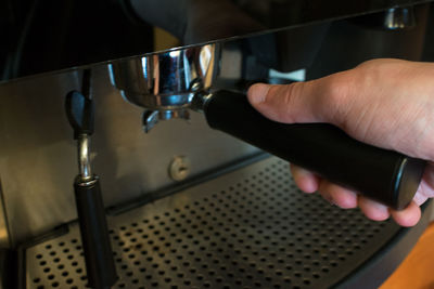 Cropped image of person holding machine
