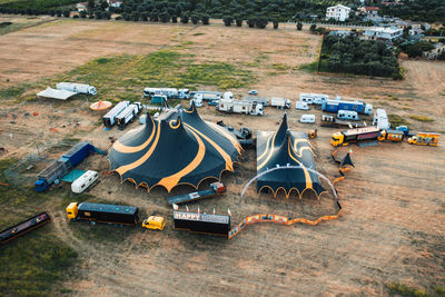 The yellow and black circus tent with animals and jugglers