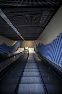 Low angle view of escalator in illuminated building