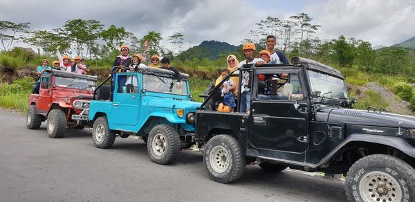 People sitting on road against sky