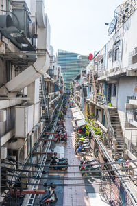 High angle view of people on road amidst buildings in city