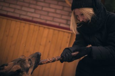 Woman playing with dog in back yard