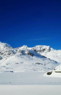 Scenic view of mountains against clear blue sky