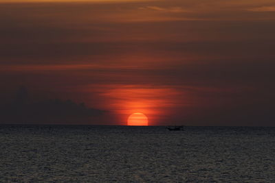 Scenic view of sea against orange sky