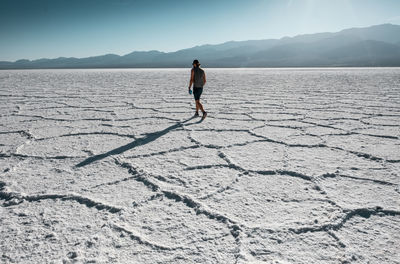 Rear view of man standing on salt flat