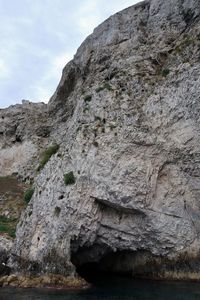 Low angle view of rock formation against sky