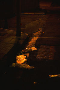 High angle view of bonfire on footpath at night