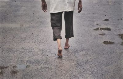 Low section of woman standing on tiled floor